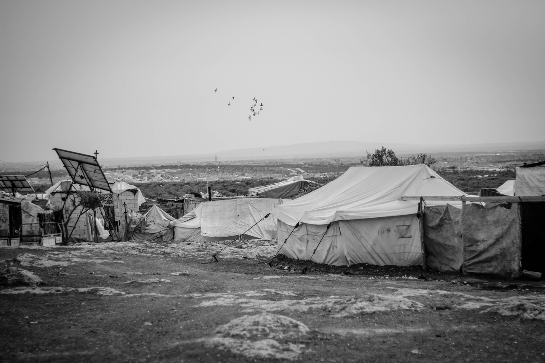a black and white photo of tents in the desert
